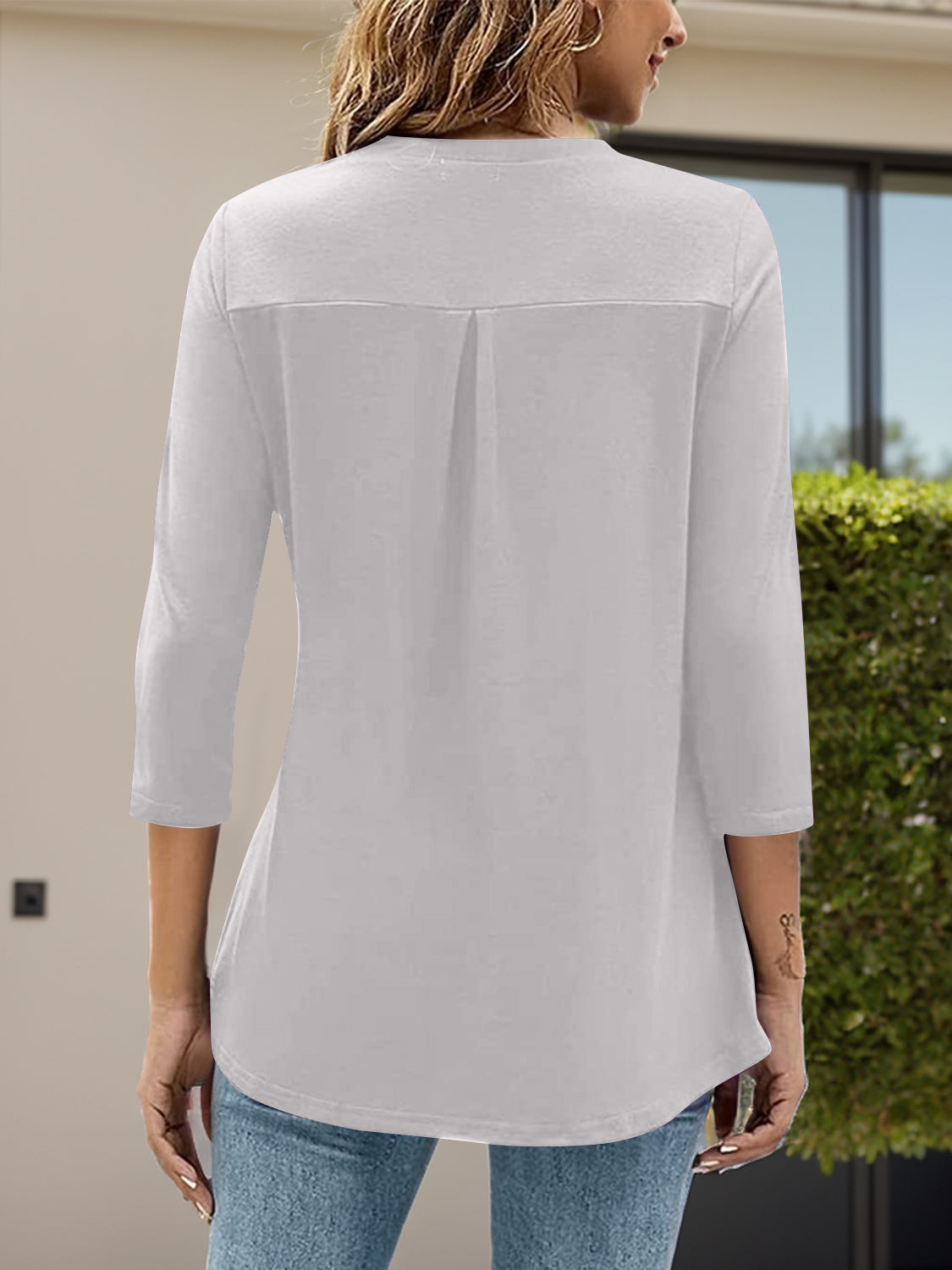 White V-neck three-quarter sleeve top with back pleat detail