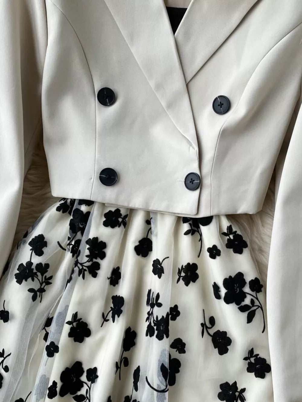Maternity midi dress with black floral overlay and matching cream double-breasted blazer.