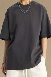 Boxy cut dark gray t-shirt with a crew neck and short sleeves.