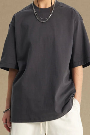 Boxy cut dark gray t-shirt with a crew neck and short sleeves.