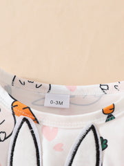 White baby dress with bunny applique, carrots, and pink hearts print.