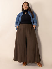 Sculpted flare palazzo trousers in dark brown with vertical seam details and pockets.