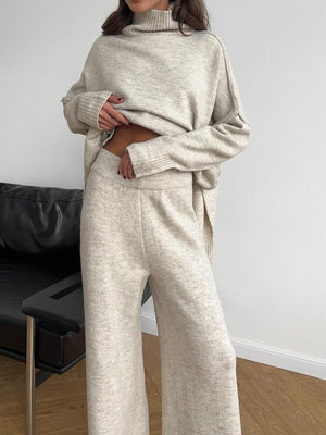 Oversized beige turtleneck lounge knit set with wide leg pants and relaxed fit sweater.