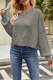Boxy ribbed knit sweater in light gray with crewneck and balloon sleeves.