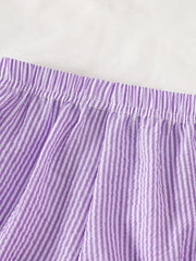 Children's purple and white striped seersucker shorts with elastic waistband.
