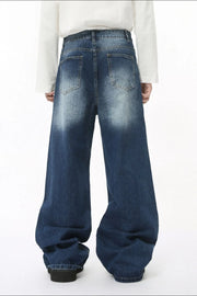 Faded wash balloon leg jeans in medium blue denim with a relaxed fit and distressed details.