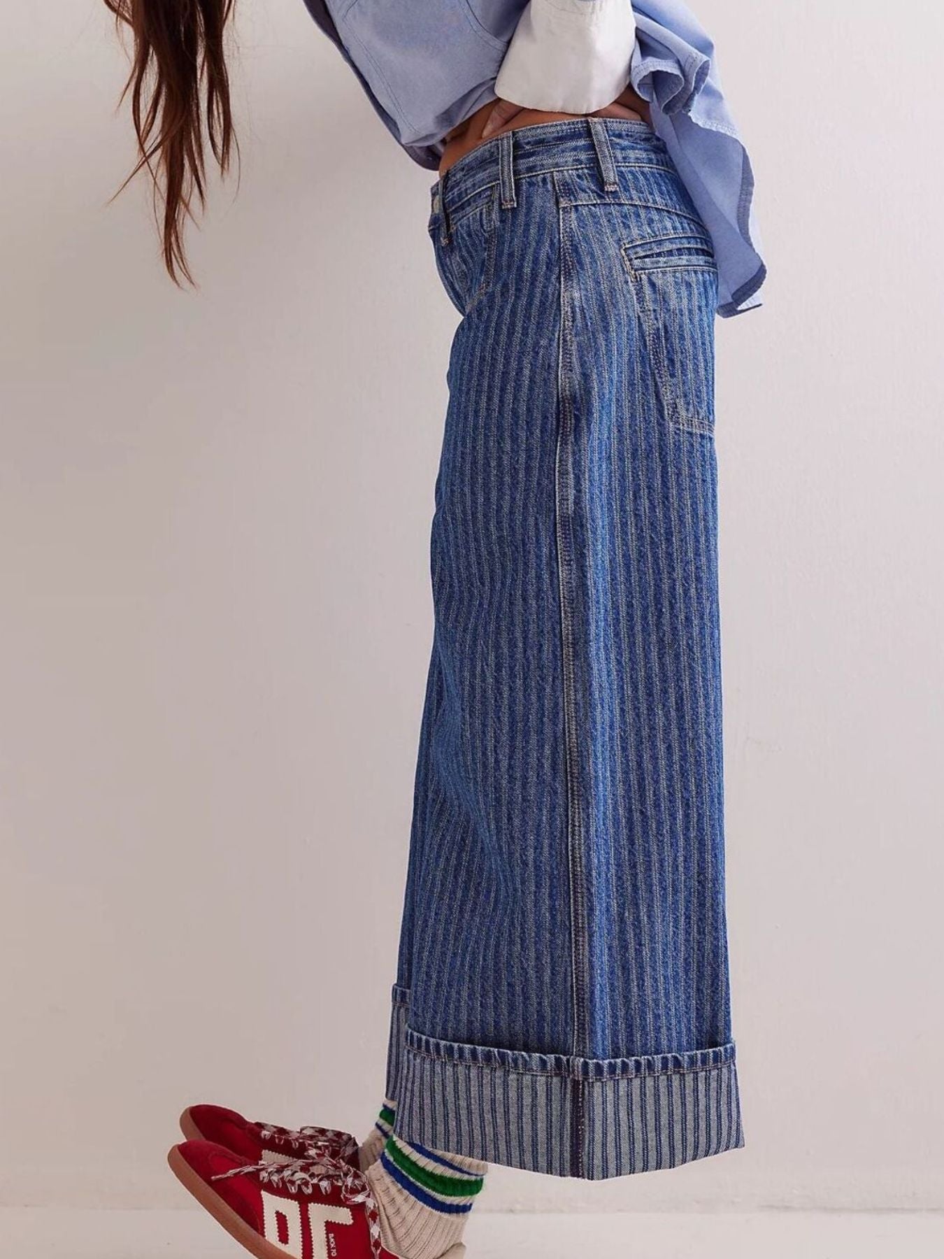 Dark blue striped high-waisted cropped jeans with wide legs and cuffed hems.