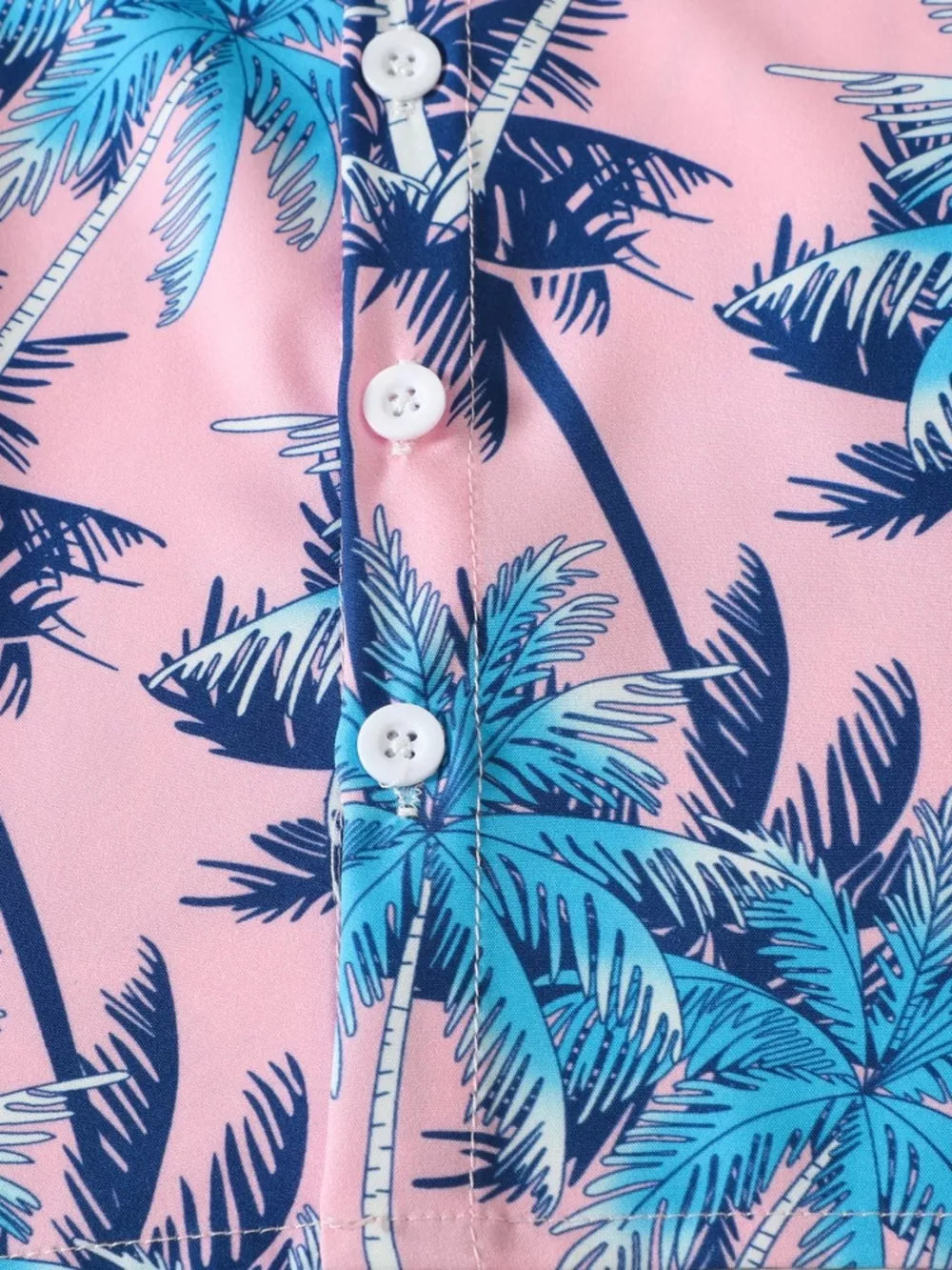Pink cotton baby shirt with blue palm tree print and white buttons