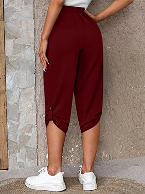 Burgundy culottes with button detail at the hem and a cropped length.