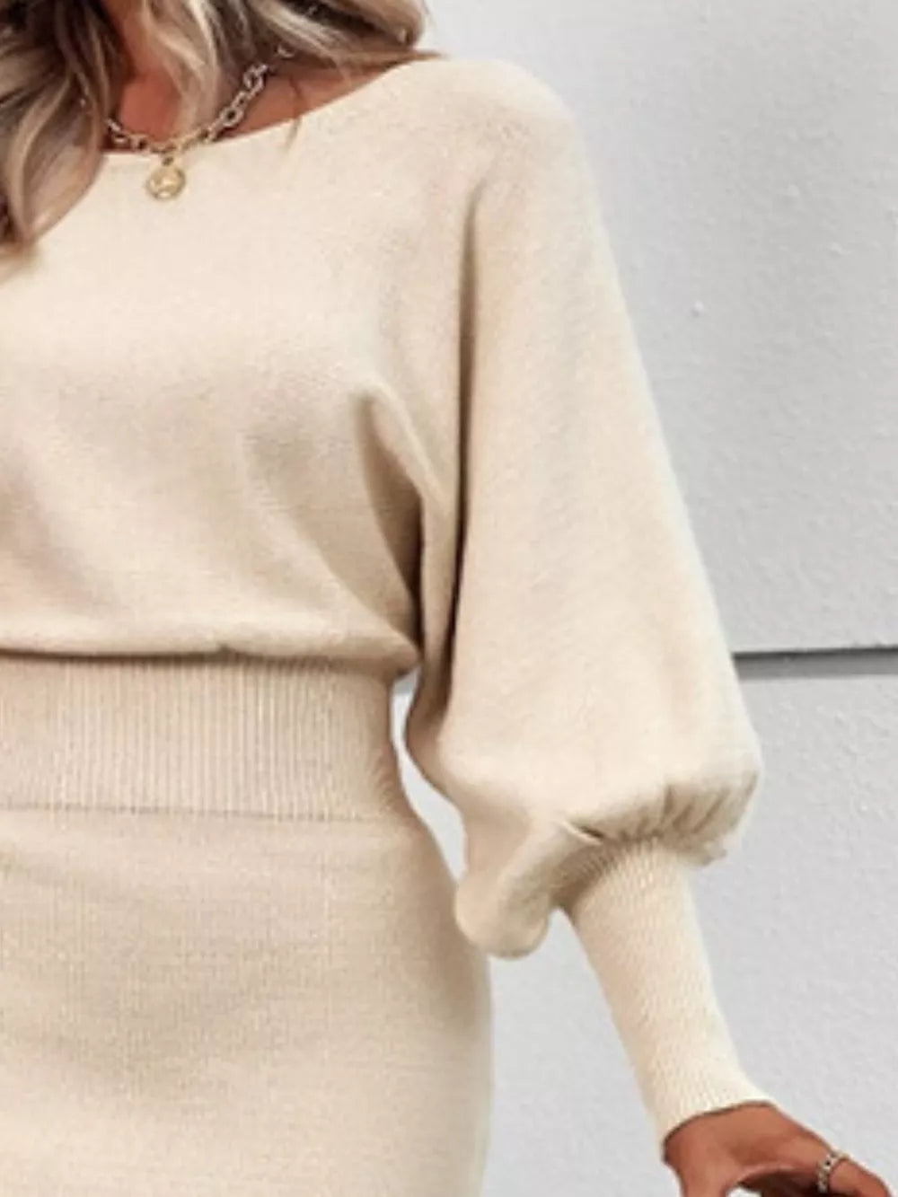 Apricot acrylic bodycon sweater dress with dramatic lantern sleeves and ribbed details.