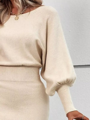 Apricot acrylic bodycon sweater dress with dramatic lantern sleeves and ribbed details.