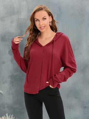 Waffle knit relaxed fit hoodie in Red Orange with v-neck and drawstring.