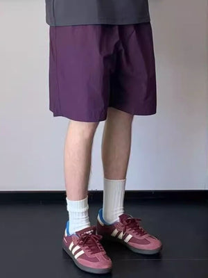Men's purple lightweight drawstring shorts with a relaxed fit.