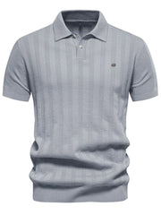 Gray ribbed knit polo shirt with vertical texture detail and short sleeves.