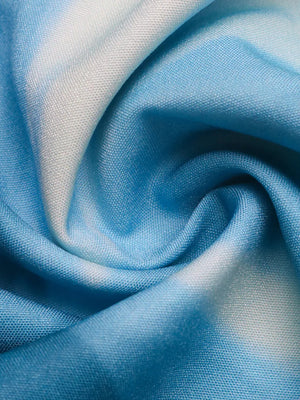 Floral sweetheart midi dress fabric detail in aqua and blue tie-dye pattern.