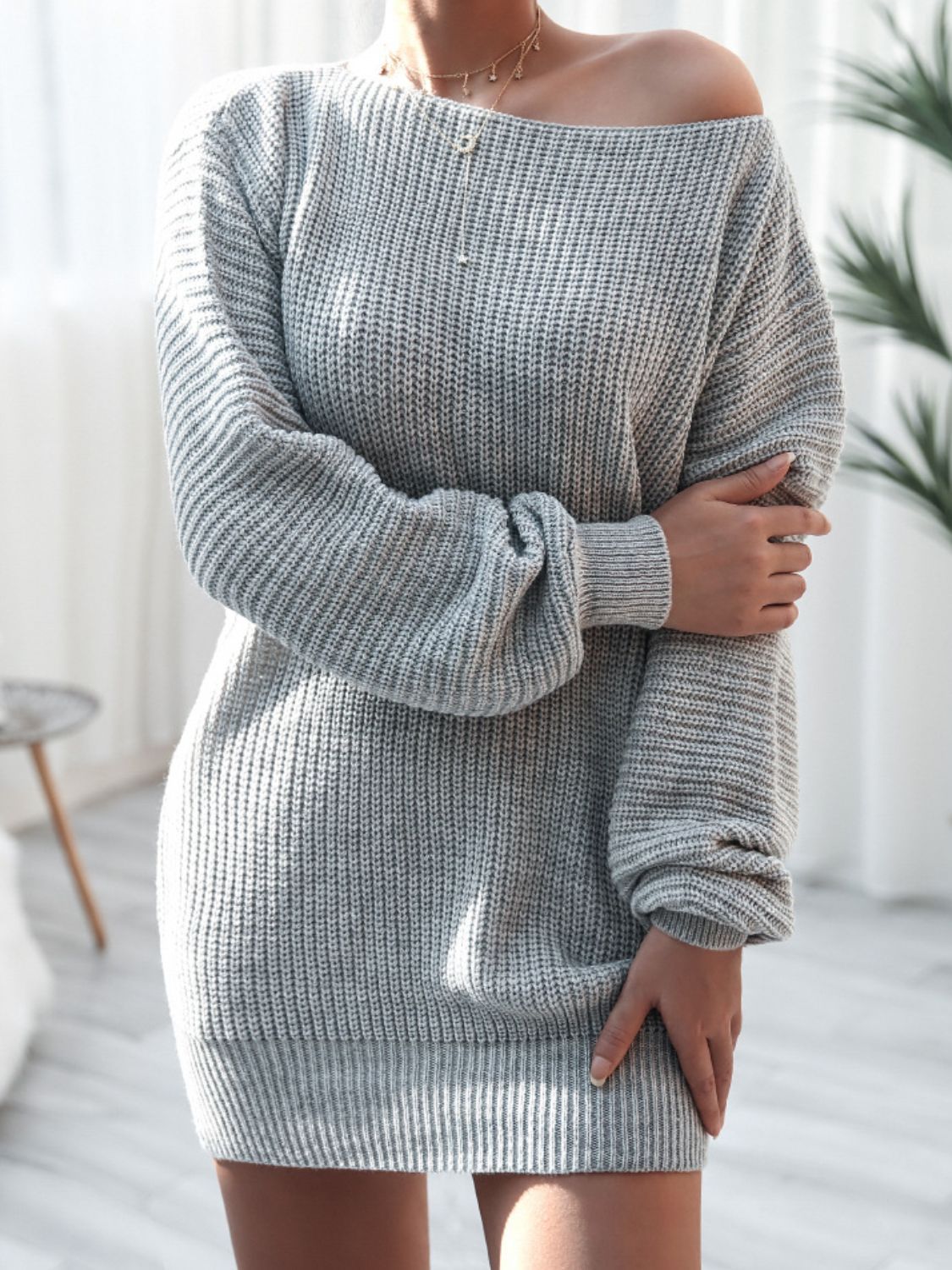 Grey balloon sleeve sweater dress with off-the-shoulder neckline and ribbed knit detail.