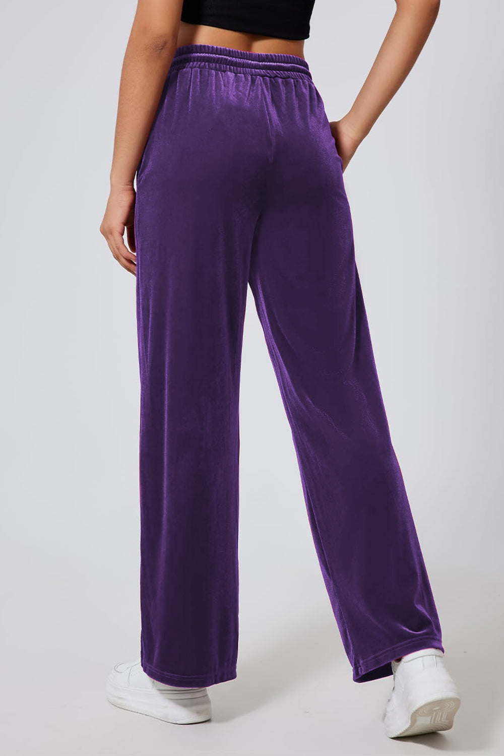 Velvet palazzo lounge trousers in violet with a drawstring waist and wide leg.