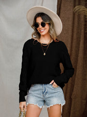 Black diamond-cut raglan knit sweater with crew neck and long sleeves.