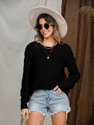 Black diamond-cut raglan knit sweater with crew neck and long sleeves.