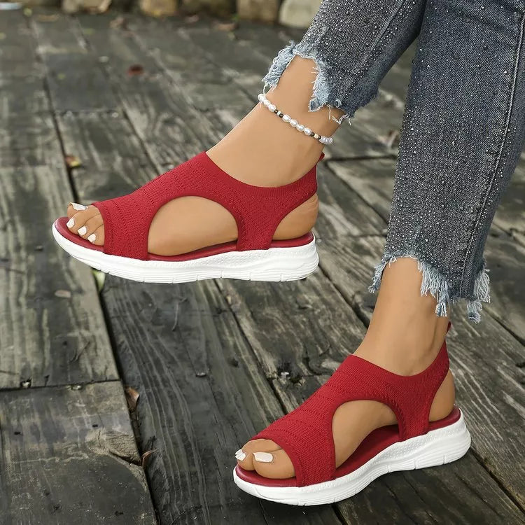 Red knit open-toe platform sandals with white soles and elastic ankle straps.