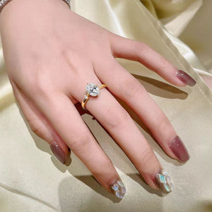 Gold moissanite ring with oval center stone and accent stones on band