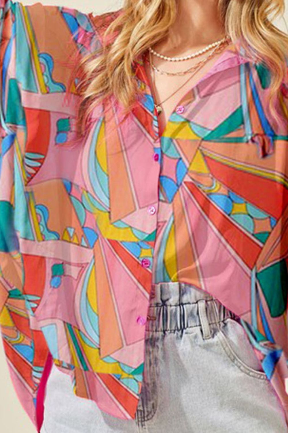 Multicolor psychedelic print batwing blouse with button front and loose sleeves.
