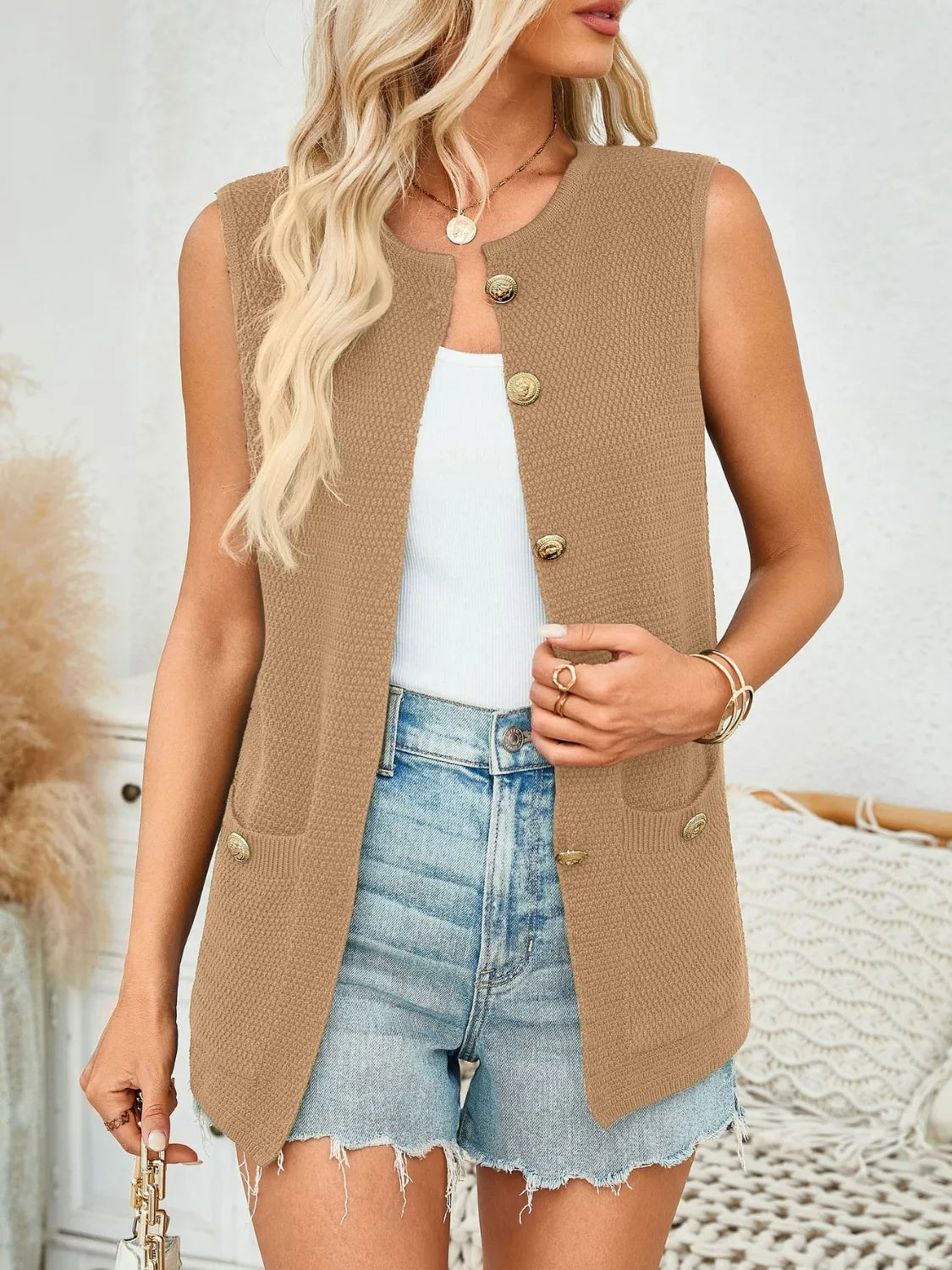 Camel knit buttoned vest with gold buttons and pocket details.