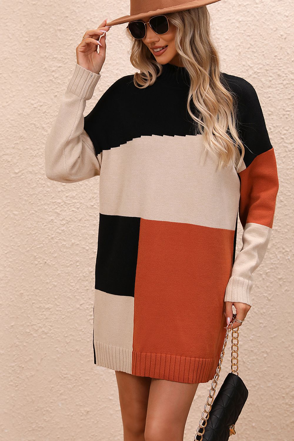 Geometric colorblock knit mini dress with mock neck and long sleeves in black, camel, ivory, and rust.