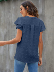 Textured voile blouse in dark blue with flutter sleeves and dotted pattern.