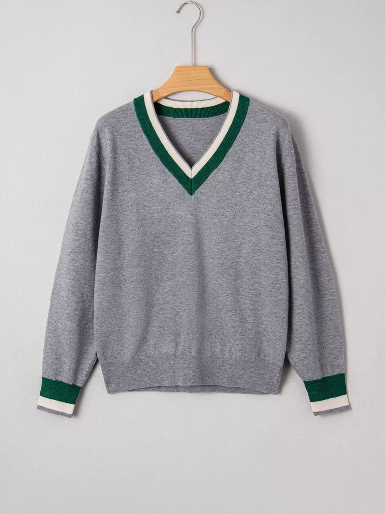 Gray ribbed V-neck sweater with green and white stripe trim on neckline and cuffs.