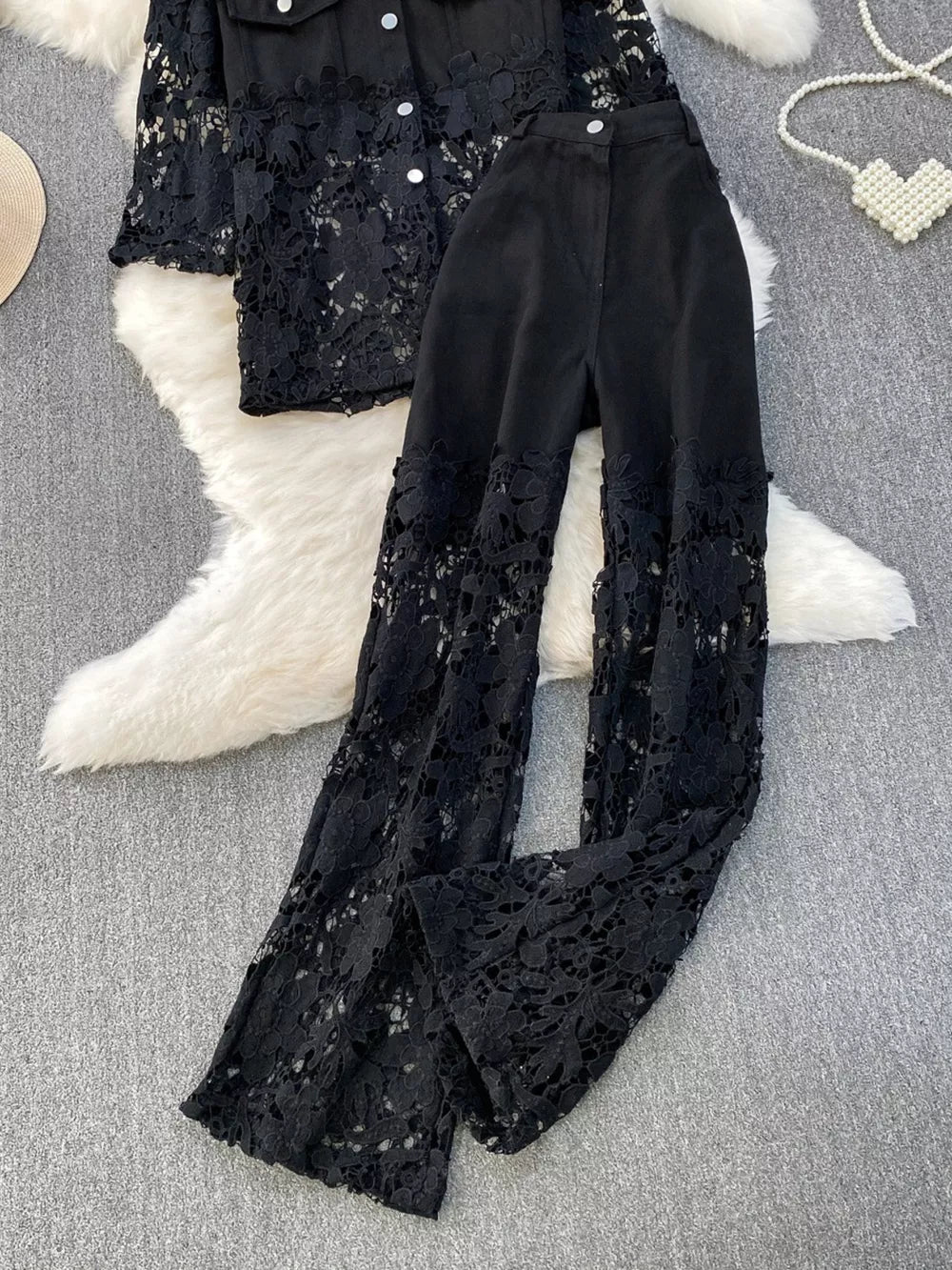Black lace-embellished two-piece set with collared button-up top and wide-leg pants.