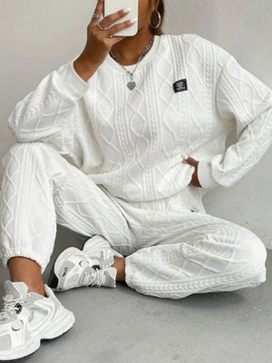 White cable knit loungewear set with crewneck sweatshirt and jogger pants.
