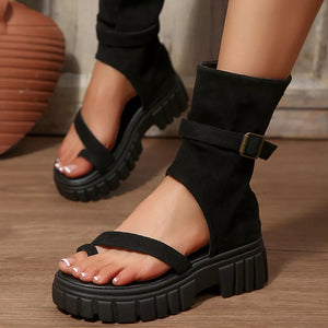 Black ankle bootie platform sandals with adjustable strap and chunky sole.