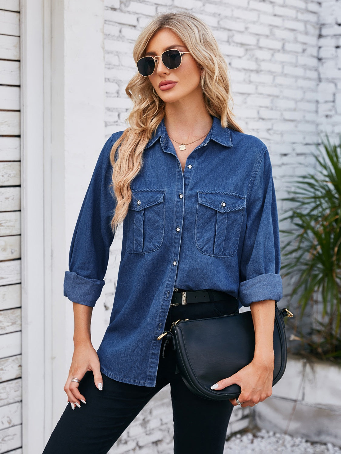 Oversized dark blue denim utility shirt with button-down front and chest pockets.
