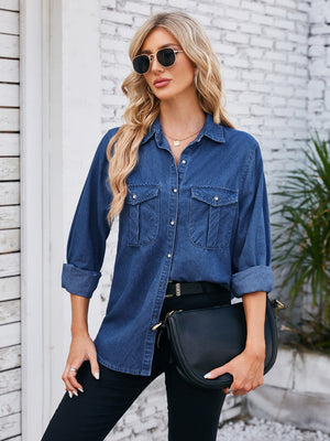 Oversized dark blue denim utility shirt with button-down front and chest pockets.