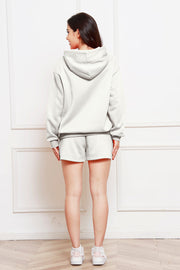 Light gray oversized hoodie and bermuda shorts set with a relaxed fit.