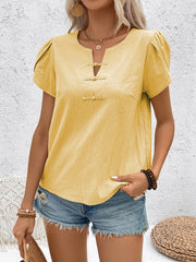 Yellow linen blouse with mandarin collar, puff sleeves, and frog button detail.