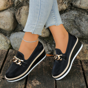 Black wedge loafers with gold chain detail and textured upper