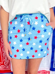 Starry drawstring mini skort with pockets in blue with red and white stars.