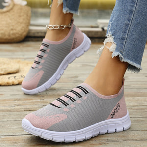 Pink and gray mesh slip-on sneakers with black stripe detail and white soles.