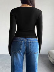 Black button-up cardigan with long sleeves, shown from the back.