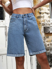 Light wash denim bermuda shorts with a rolled hem and button fly.