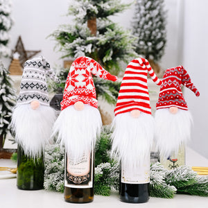 Festive gnome bottle toppers in red, white and grey knit patterns.