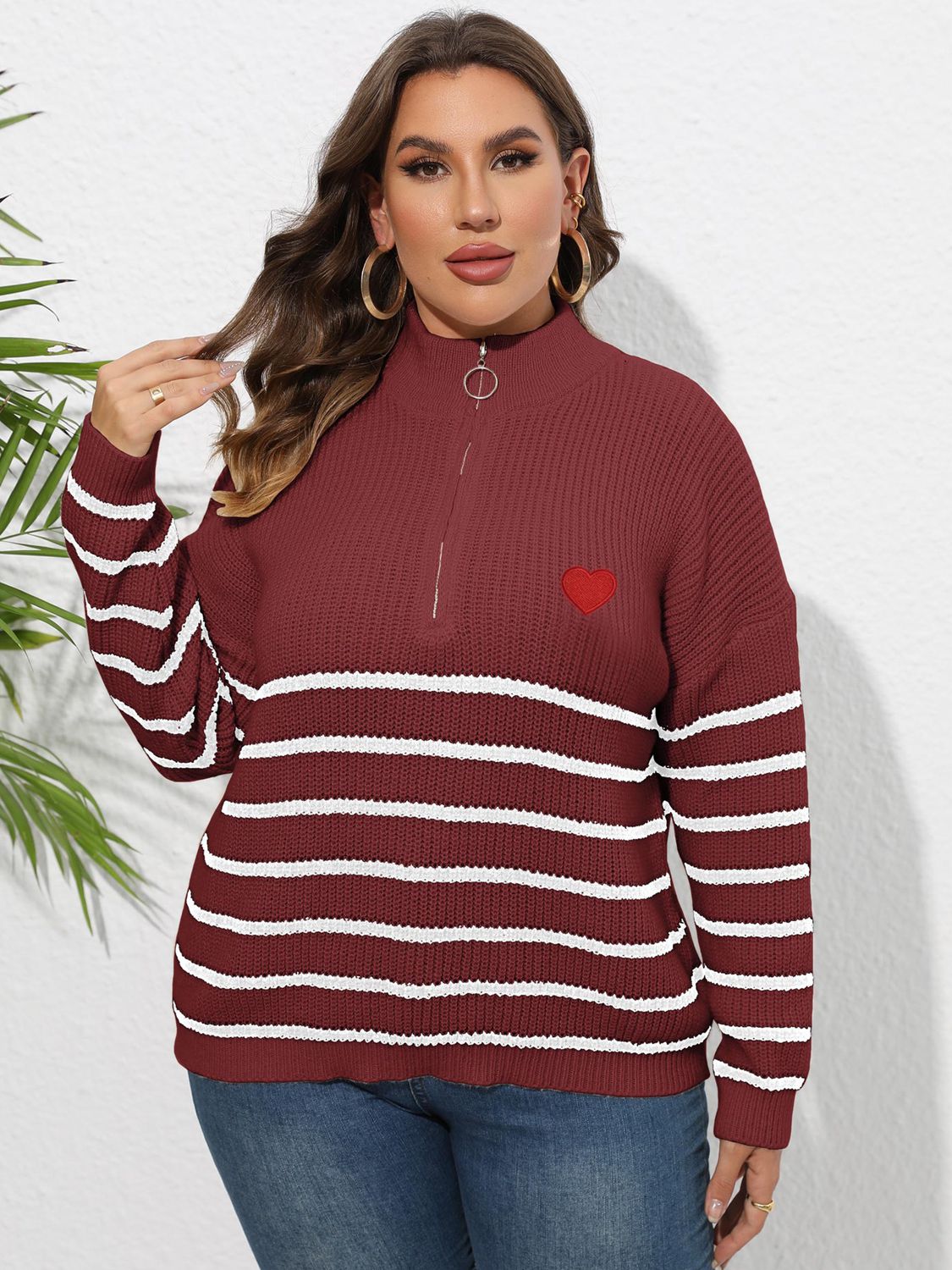 Burgundy striped ribbed knit sweater with mock neck, quarter zip, and red heart appliqué.