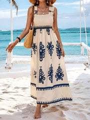 Smocked square neck maxi dress in cream with blue paisley print and ruffle straps.