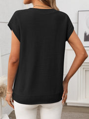 Black cable knit vest with V-neck and short sleeves, ribbed hem detail.