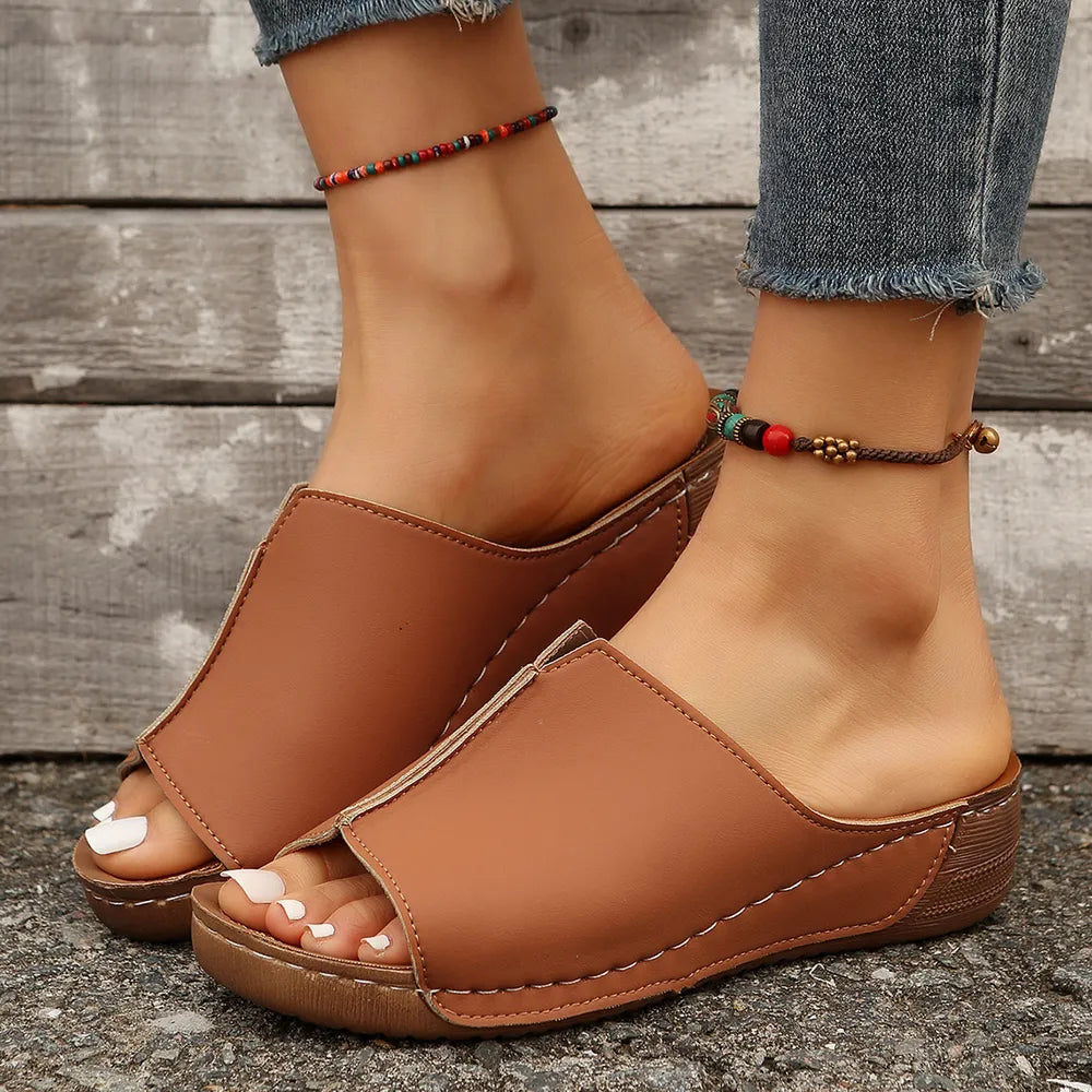 Ochre stitched edge wedge mules with peep toe and stacked heel.