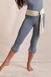 Dusty blue flared hem crop leggings with a cream sash belt.