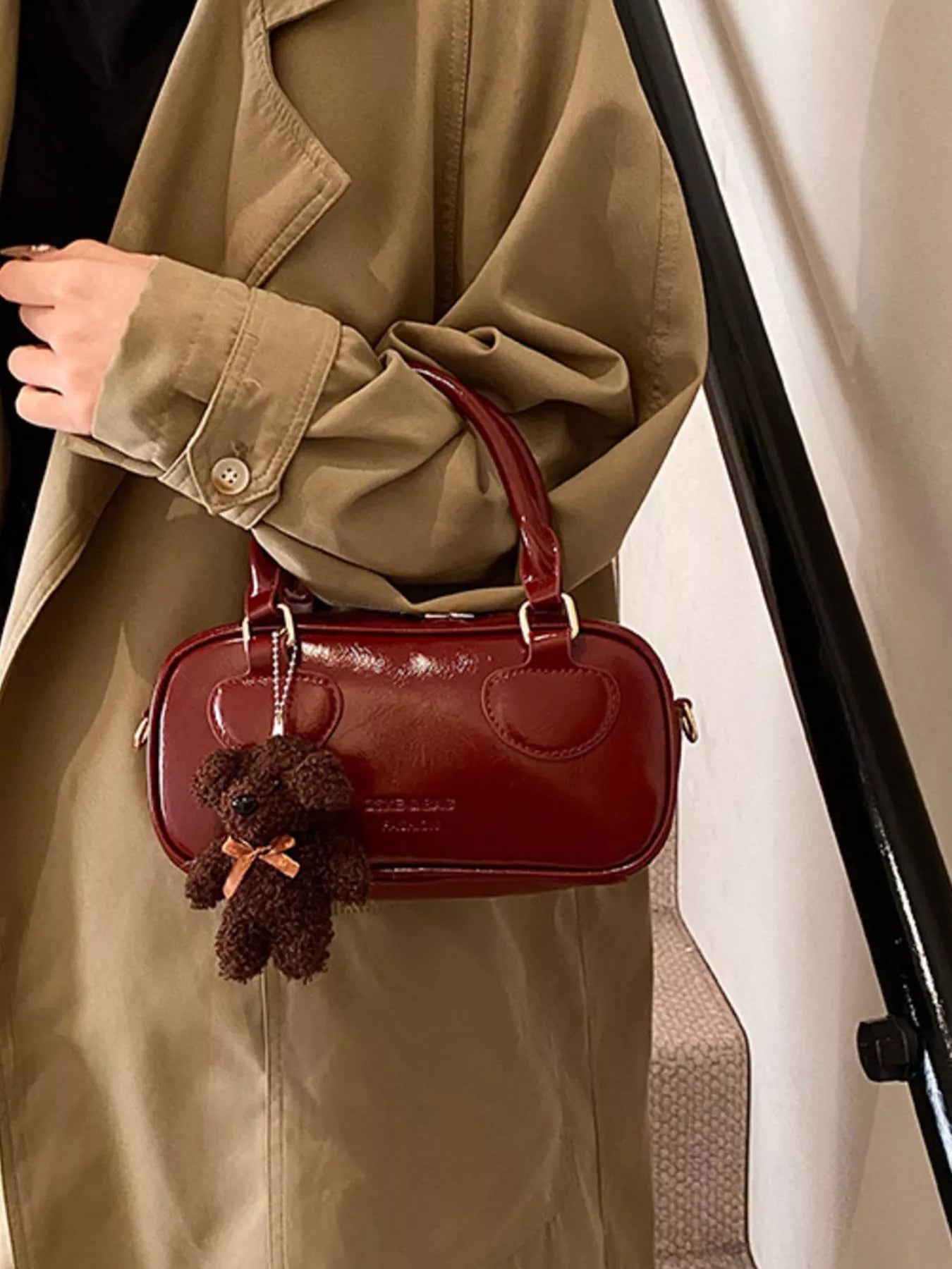 Chic mini crossbody bag in deep red PU leather with a teddy bear charm.
