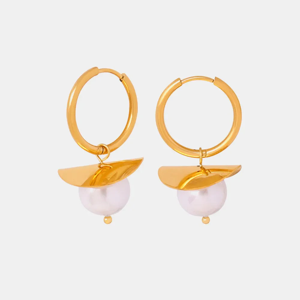 Gold hoop earrings with a petal detail and a single pearl drop.